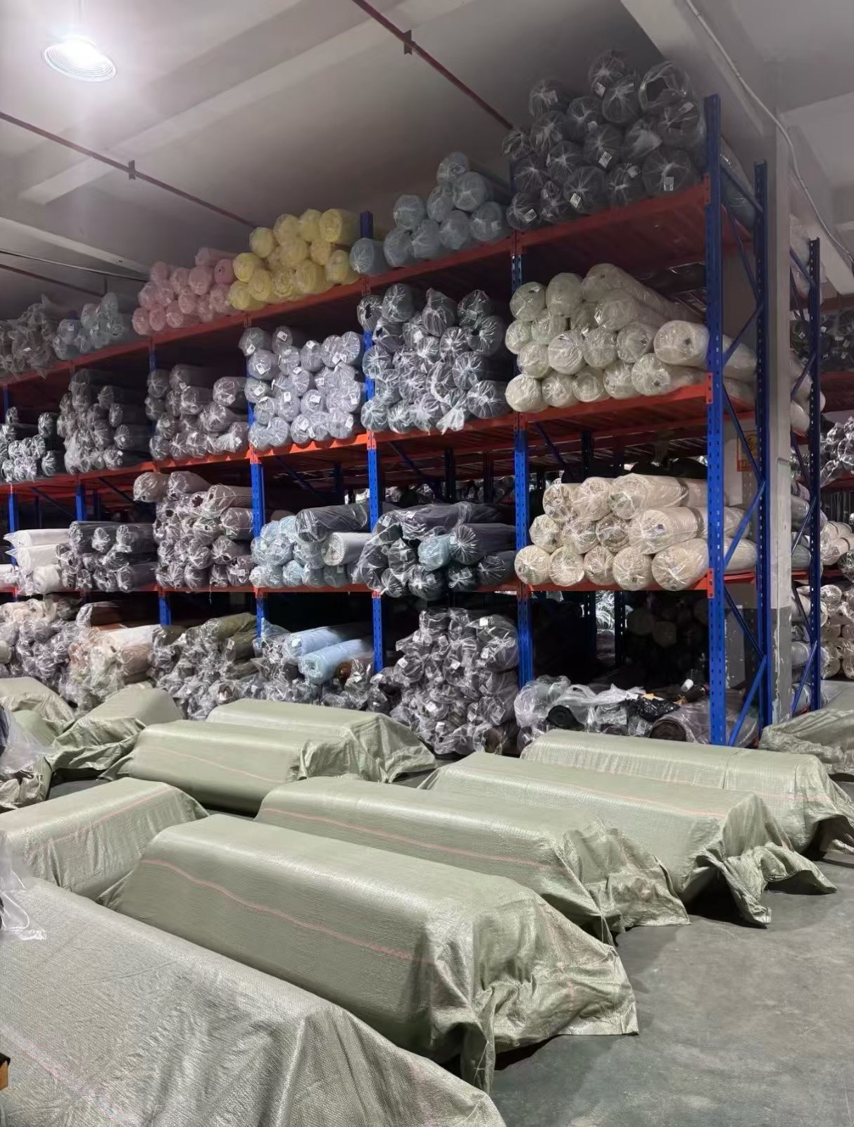 Fabric rolls organised in warehouse storage